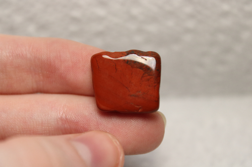 Polished red stone with black veins.
